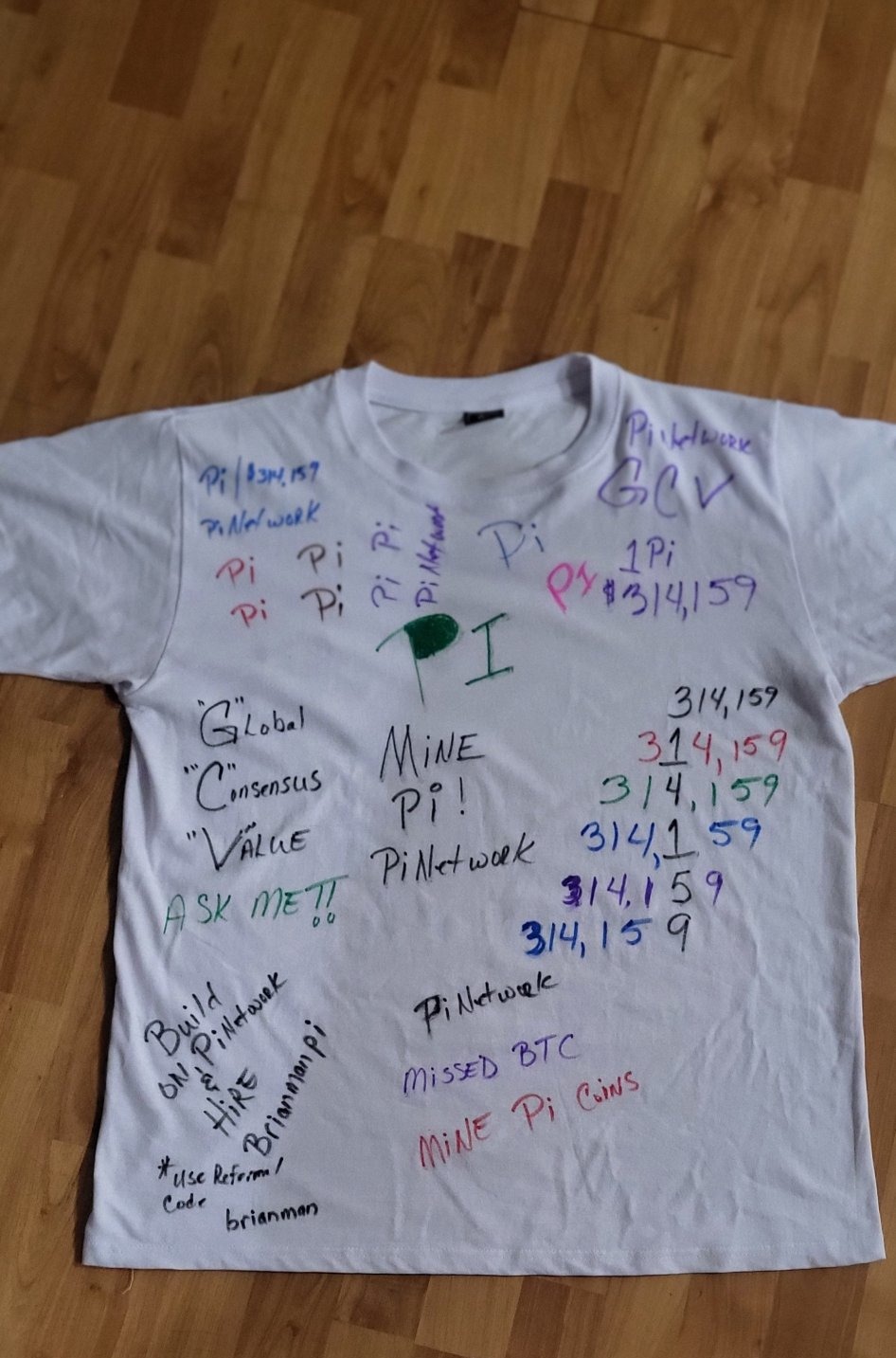 Front of the full white Pi Network shirt covered with handwritten Pi and GCV messages